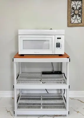 a microwave oven on a white shelf in a kitchen at Newly Renovated 3BR Orangeville Basement Suite with Private Access, 10 Min Walk to Headwaters Hospital, 5 Min Drive to Mount Alverno! Ideal for Medical Stay, Family Travel & Work Trips! in Orangeville