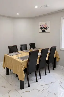a dining room with a table and chairs at Newly Renovated 3BR Orangeville Basement Suite with Private Access, 10 Min Walk to Headwaters Hospital, 5 Min Drive to Mount Alverno! Ideal for Medical Stay, Family Travel & Work Trips! in Orangeville