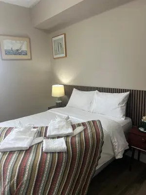 a hotel room with a bed with towels on it at Downtown Private Room Central Location in Toronto