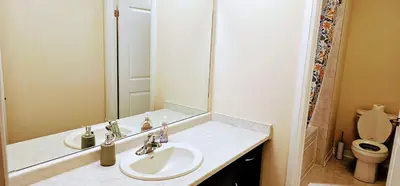a bathroom with a sink and a mirror and a toilet at Luxury 5 Bed Retreat for 12 with Gourmet Kitchen in Paris