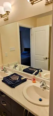 a bathroom with a sink and a large mirror at Luxury 5 Bed Retreat for 12 with Gourmet Kitchen in Paris