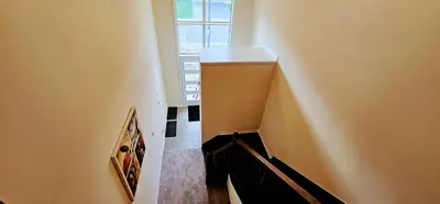 a hallway with a stairway leading to a window at Luxury 5 Bed Retreat for 12 with Gourmet Kitchen in Paris