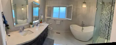 a bathroom with two sinks and a tub and a shower at Master bedroom suite on the 2nd floor, city center in Mississauga