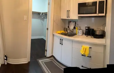 a small kitchen with a sink and a microwave at Master bedroom suite on the 2nd floor, city center in Mississauga