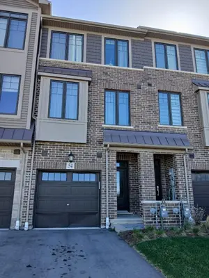 a large brick house with a garage at Home away from home in Cambridge