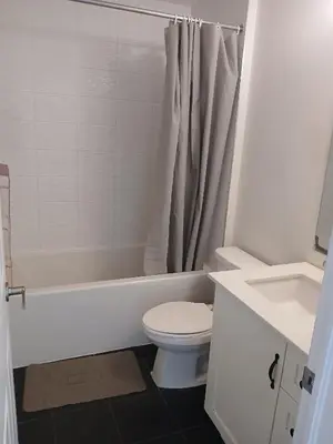 a bathroom with a toilet and a tub and a sink at Home away from home in Cambridge