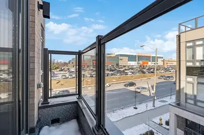 a balcony with a view of a parking lot at Stunning 2BR Toronto Retreat, Patio & Parking in Toronto