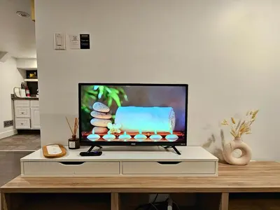 a flat screen tv sitting on top of a table at Downtown Queen and King St - Lower Suite in Toronto