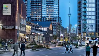 a group of people crossing a street in a city at Downtown Queen and King St - Lower Suite in Toronto