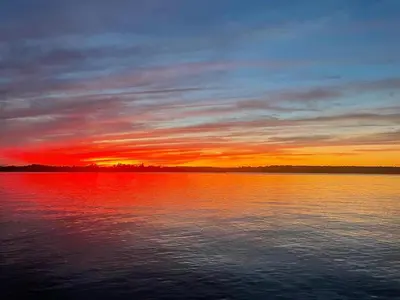 a sunset over a large body of water at Rice Lake Retreat in Roseneath