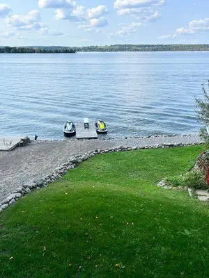 two boats on the shore of a large body of water at Rice Lake Retreat in Roseneath