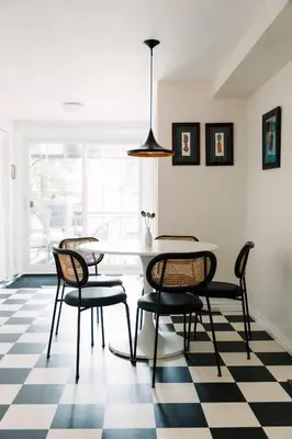 a dining room with a table and chairs on a checkered floor at The County Queen - Historic Home in Picton in Picton