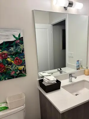 a bathroom with a painting of roses on the wall at Beautiful Quaint Home in Port Credit, Mississauga in Mississauga