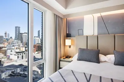 a bedroom with a bed and a large window at Riu Plaza Toronto in Toronto