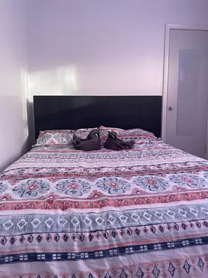 a bed with shoes sitting on top of it at The Basics - Private Room in Toronto