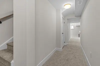 a hallway with white walls and stairs in a house at Luxury Townhome in Oakville