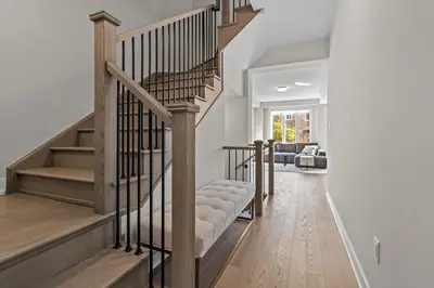 a staircase in a living room with wooden floors at Luxury Townhome in Oakville