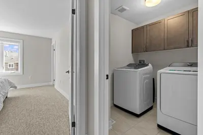 a laundry room with a washer and dryer at Luxury Townhome in Oakville