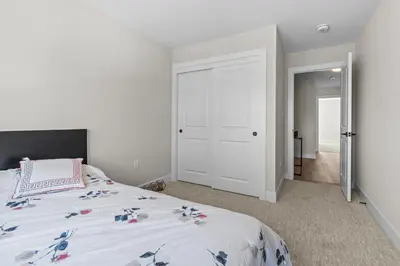 a bedroom with a bed with a white bedspread at Luxury Townhome in Oakville