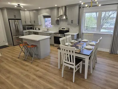 a kitchen with a table and chairs in a kitchen at Streetsville Retreat - Prime Location in Mississauga