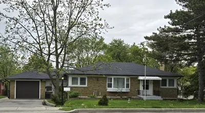a brick house with a black roof at Streetsville Retreat - Prime Location in Mississauga