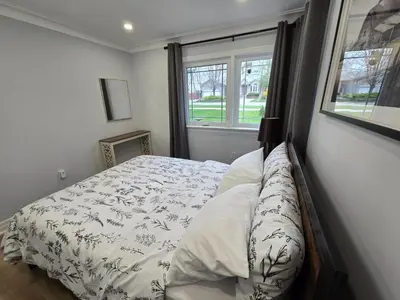 a bedroom with a bed and a window at Streetsville Retreat - Prime Location in Mississauga