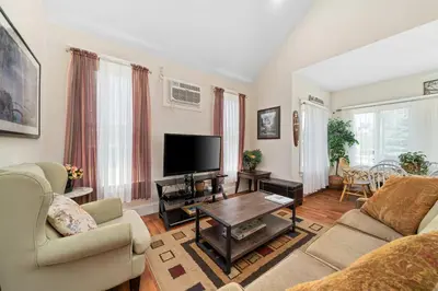 a living room with a couch and a tv at The Sumac - 8 Natures in Cherry Valley