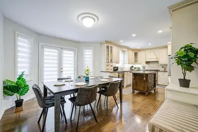 a dining room with a table and chairs in a kitchen at Upper-Level Classic House in Richmond Hill in Richmond Hill