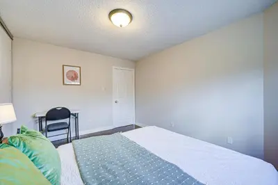 a bedroom with a bed and a desk with a chair at Upper-Level Classic House in Richmond Hill in Richmond Hill
