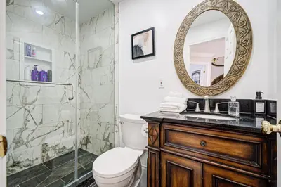 a bathroom with a shower and a toilet and a mirror at Upper-Level Classic House in Richmond Hill in Richmond Hill