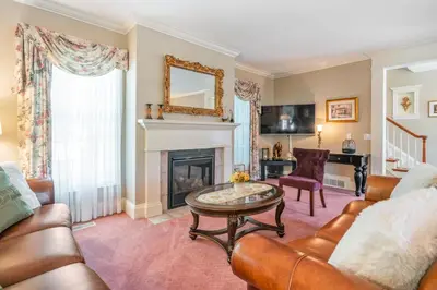 a living room with a couch and a fireplace at John & Gate House boutique Bed and Breakfast in Niagara on the Lake