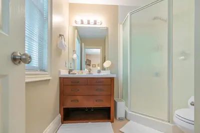 a bathroom with a shower and a sink and a mirror at John & Gate House boutique Bed and Breakfast in Niagara on the Lake