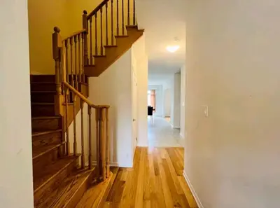 an empty hallway with a staircase in a house at Stay 15 mins from Niagara Falls-5 Bedroom nights Inn in Thorold