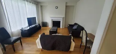 a living room with a couch and a tv at Stay 15 mins from Niagara Falls-5 Bedroom nights Inn in Thorold