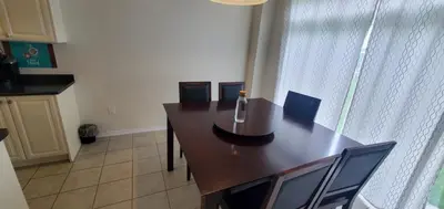 a dining room table with chairs and a bottle on it at Stay 15 mins from Niagara Falls-5 Bedroom nights Inn in Thorold