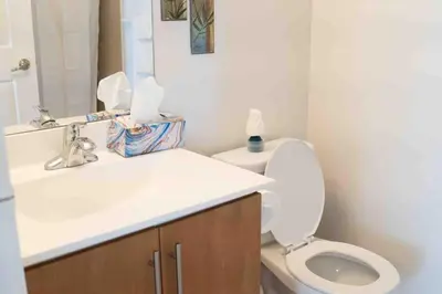 a bathroom with a white toilet and a sink at Spacious 2 bedrooms 2 bathrooms with Cozy Charm plus 1 Parking in Mississauga
