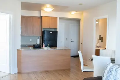 a kitchen with a island in the middle of a room at Spacious 2 bedrooms 2 bathrooms with Cozy Charm plus 1 Parking in Mississauga