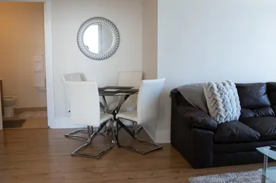 a living room with a couch and a table at Spacious 2 bedrooms 2 bathrooms with Cozy Charm plus 1 Parking in Mississauga