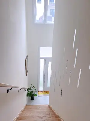 a hallway with a white door and a window at Modern entire house close to Costco convenient stay in Richmond Hill