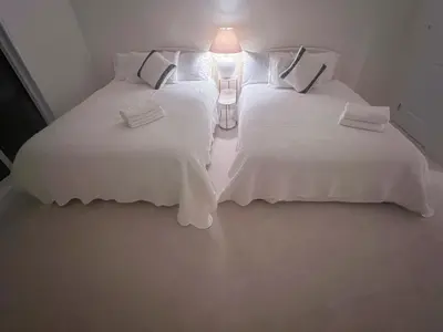 two beds with white sheets and a lamp in a room at Modern entire house close to Costco convenient stay in Richmond Hill