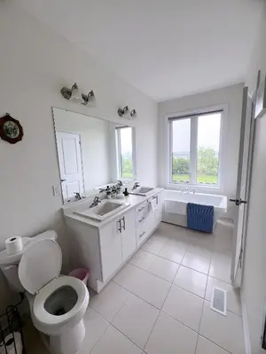 a bathroom with a toilet and a sink and a tub at Modern entire house close to Costco convenient stay in Richmond Hill