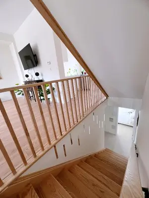 a staircase in a house with white walls and wood floors at Modern entire house close to Costco convenient stay in Richmond Hill