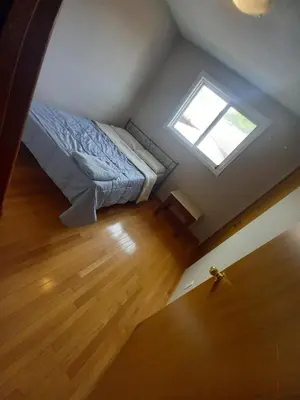 a small bedroom with a bed and a window at Stay in Waterloo-Kitchener-Downtown-FREE WIFI & PARKING in Waterloo
