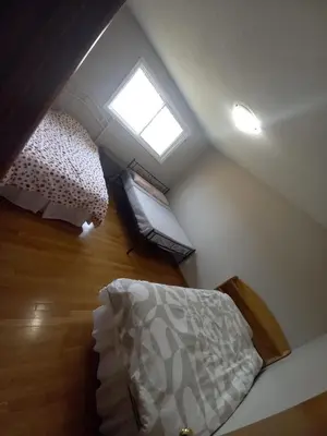 a attic bedroom with two bunk beds and a window at Stay in Waterloo-Kitchener-Downtown-FREE WIFI & PARKING in Waterloo