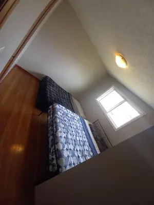 a bedroom with a bed and a window at Stay in Waterloo-Kitchener-Downtown-FREE WIFI & PARKING in Waterloo