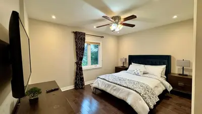 a bedroom with a bed and a ceiling fan at Massive Luxury Retreat with Gym, Sauna, Games and More in Mississauga