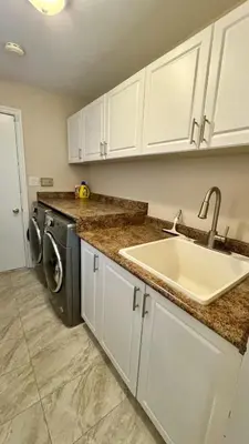 a kitchen with a sink and a washing machine at Massive Luxury Retreat with Gym, Sauna, Games and More in Mississauga