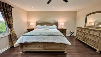 a bedroom with a bed and two dressers and a mirror at Massive Luxury Retreat with Gym, Sauna, Games and More in Mississauga