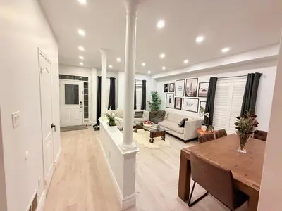 a living room with a table and a couch at Welcome to Your Home Away From Home! in Mississauga
