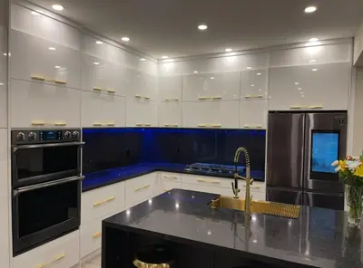 a kitchen with white cabinets and a black refrigerator at Welcome to Your Home Away From Home! in Mississauga